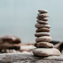 rock-stack-on-log-by-water